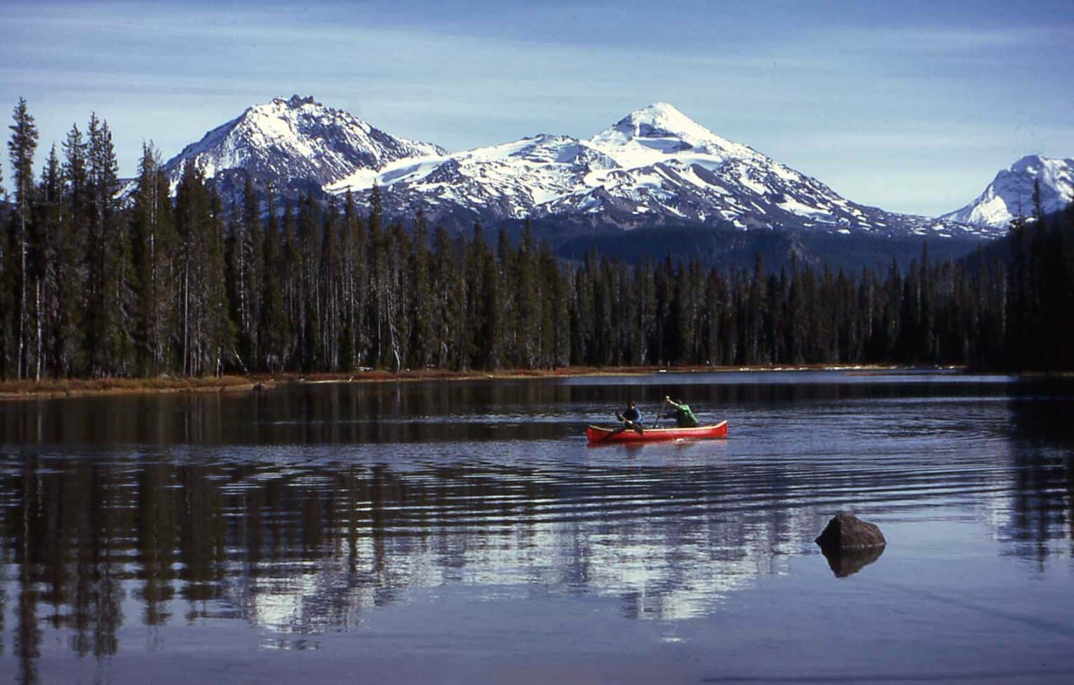 canoeing on lake with beautiful icy mountains in the back