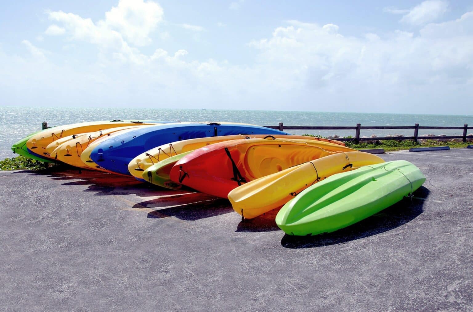 colorfull recreational kayaks laying next to each other