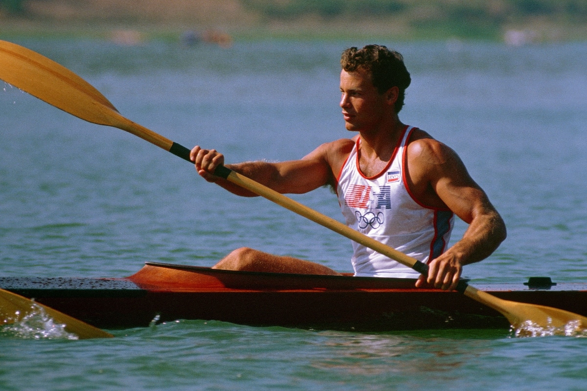 muscular guy kayaking