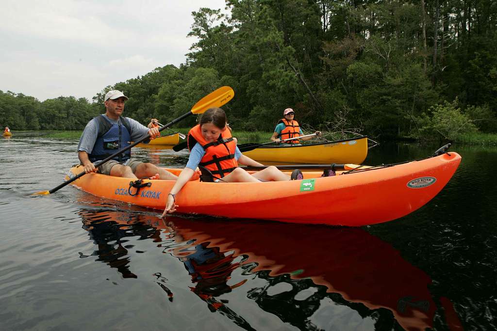 young child enjoys the water during a kayak trip