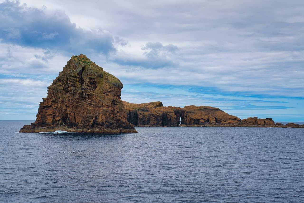 Majestic rock formations off the coast of the Azores, Portugal with overcast skies